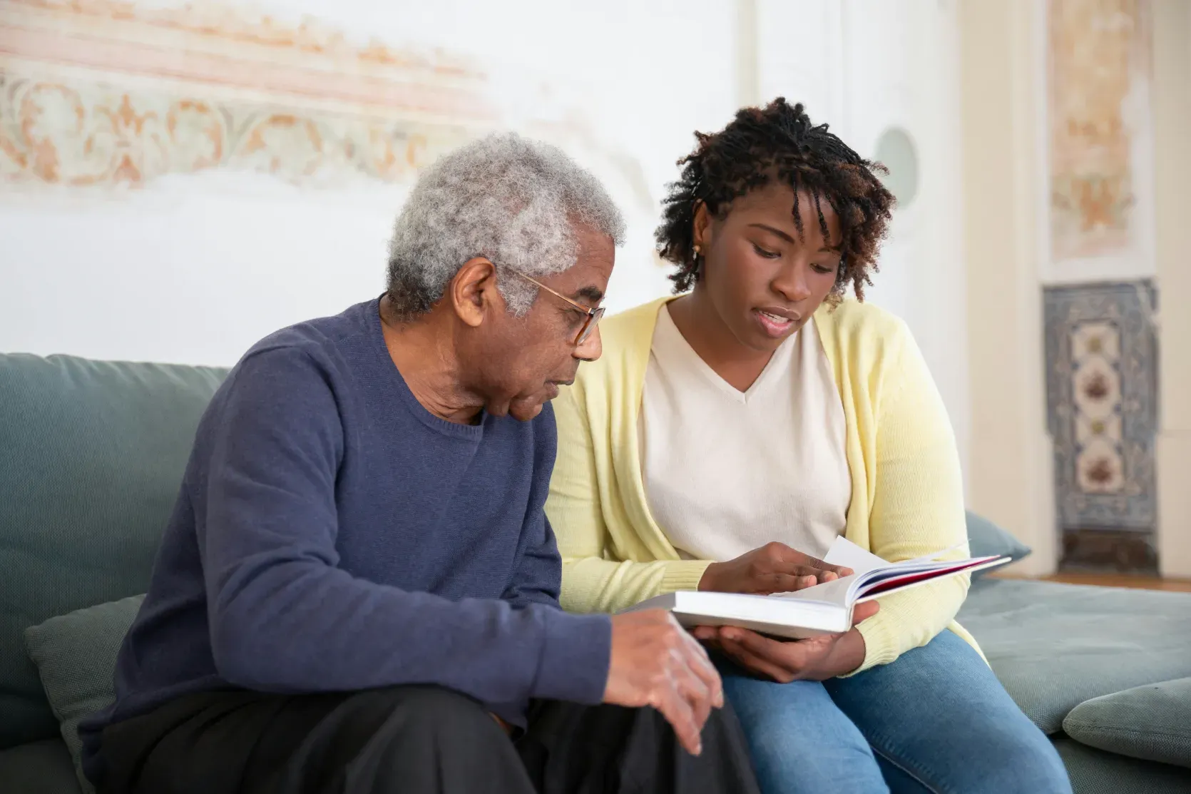 Elderly patient with doctor looking at clinical trial options.